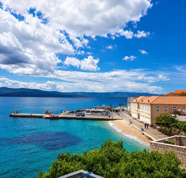 Bol seafront promenade under a summer sky